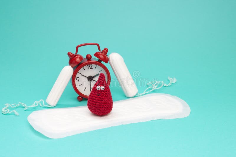 Red alarm clock, dreamy smile crochet blood drop, daily menstrual pad and tampons. Menstruation sanitary woman hygiene. Woman crit royalty free stock photography Red alarm clock, dreamy smile crochet blood drop, daily menstrual pad and tampons. Menstruation sanitary woman hygiene. Woman crit royalty free stock photography
