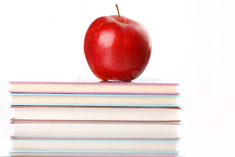 Red apple on a book stock image