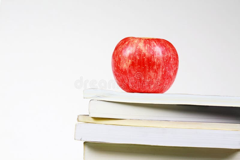 Red apple and many books