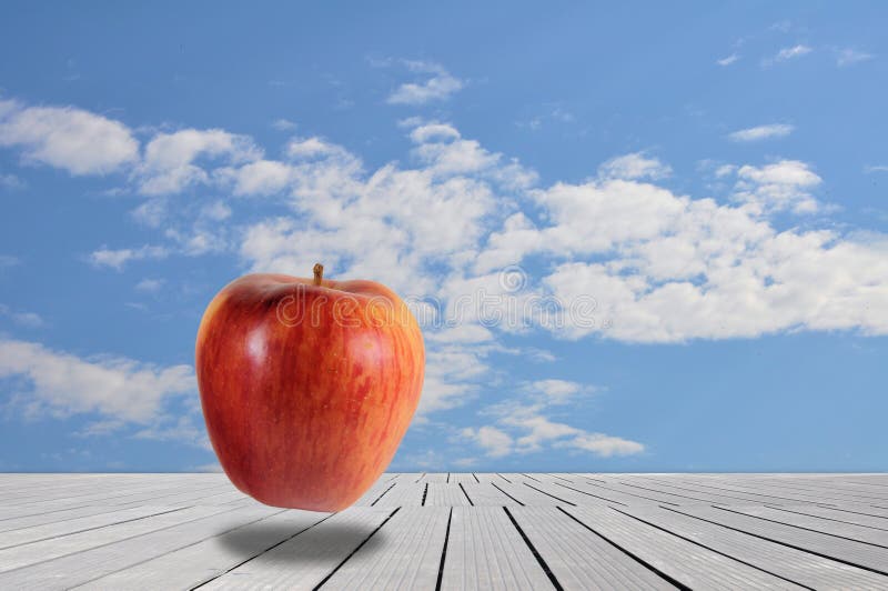 Red Apple in Surreal Landscape with Cloudy Sky Stock Image Image of
