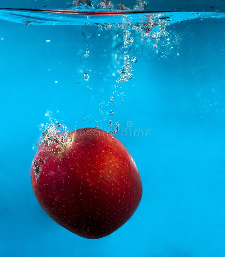 Red Apple in Water with Splash and Drops Over Blue Stock Photo Image of ring, thirsty 83555422