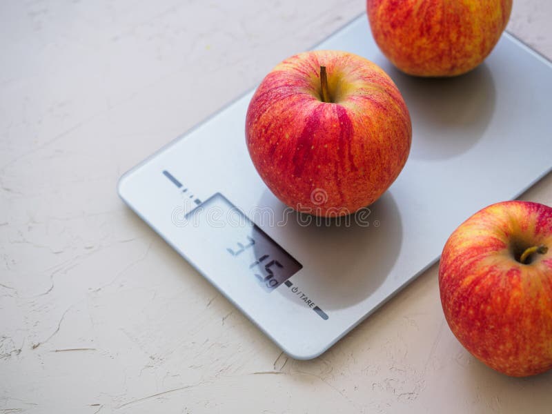 Two apples on a digital kitchen scale - Stock Image - H305/0140 - Science  Photo Library