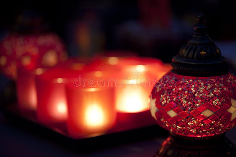 Red Arabian style candle holder with chandeliers.