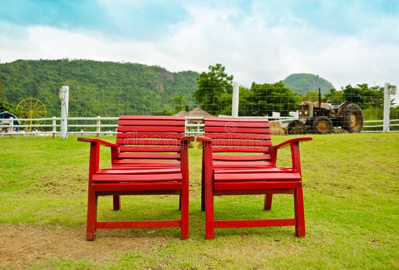 Red armchair in farmland
