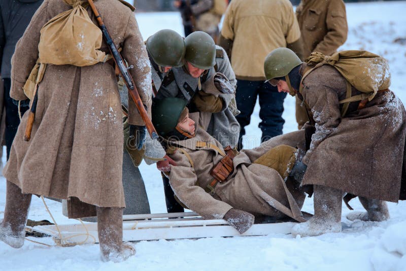 Red Army medics in action with the injured soldier.