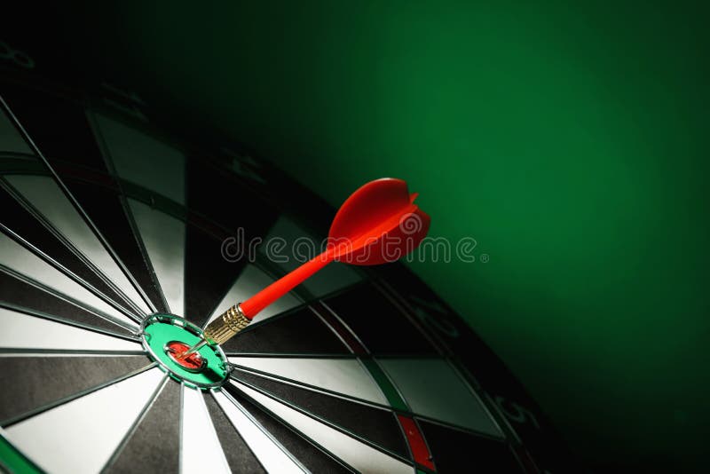 Red arrow hitting target on dart board against green . Space for text