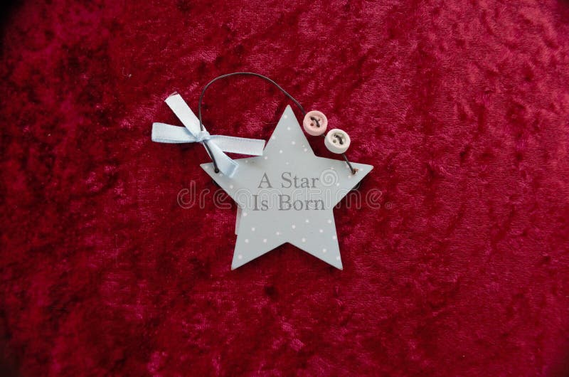 Red background with A Star Is Born blue star shape with a bow and buttons