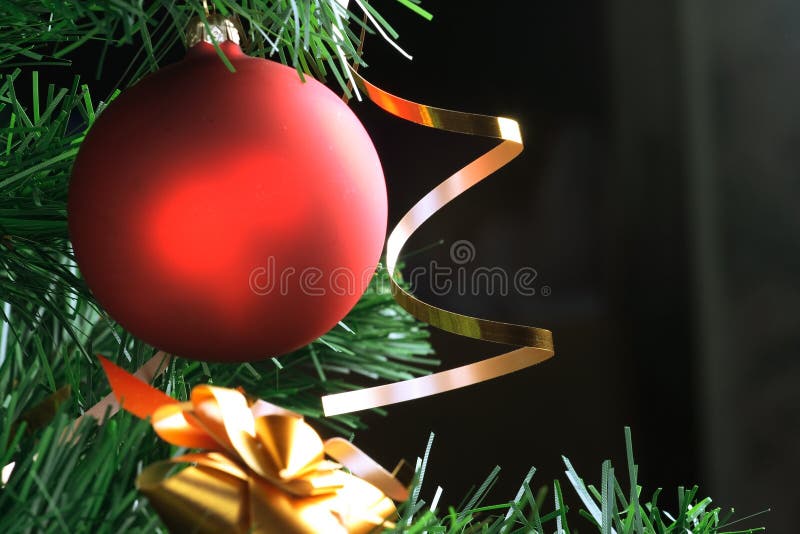 Red ball hanging from christmas tree