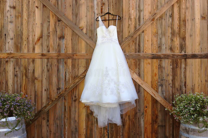 Red Barn door white wedding dress. Floral edges rustic wood