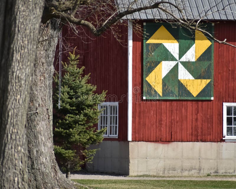 Red Barn with Green Gold and White Quilt