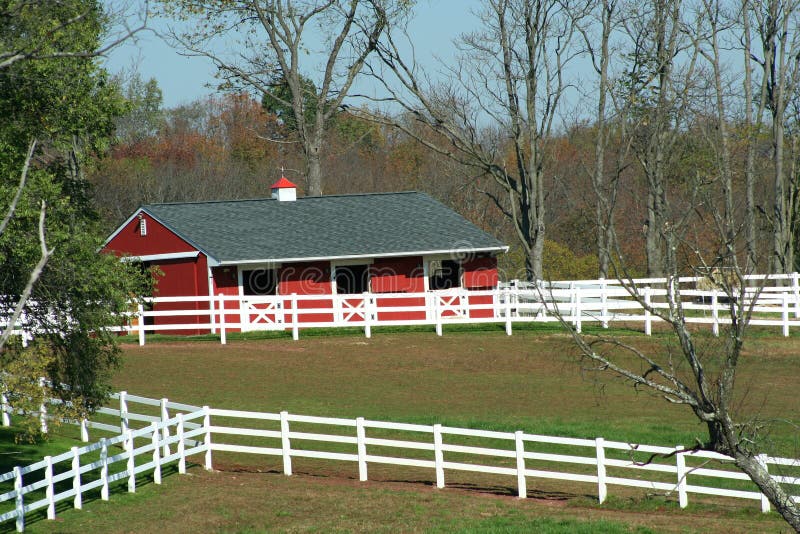 Red Barn and white fence stock image