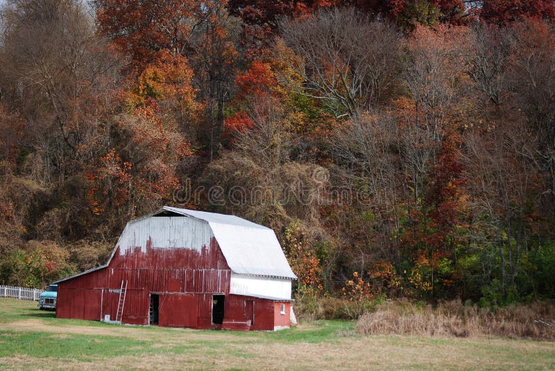 Red barn with white roof in the autumn in rural Indiana.