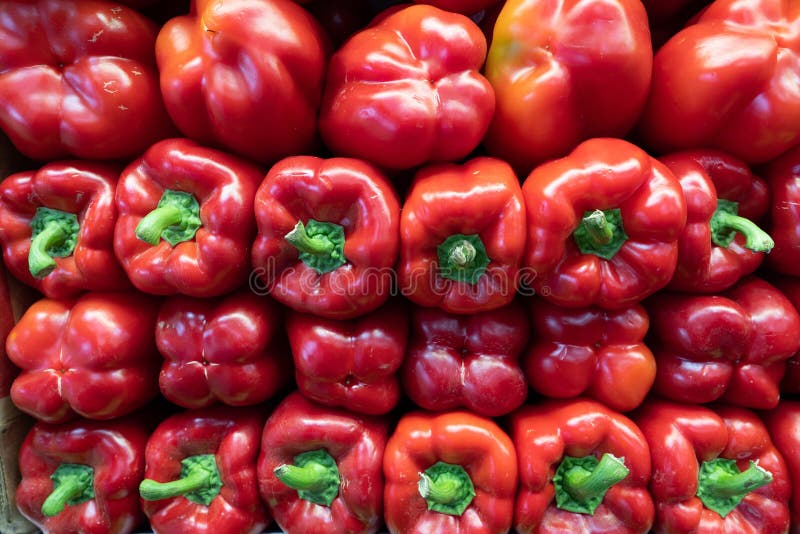 Red Bell Peppers Piled High on Sides in Grocery Store Stock Photo