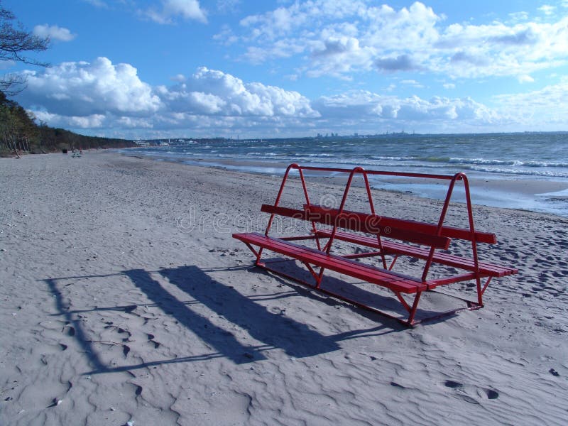 Red bench on the beach