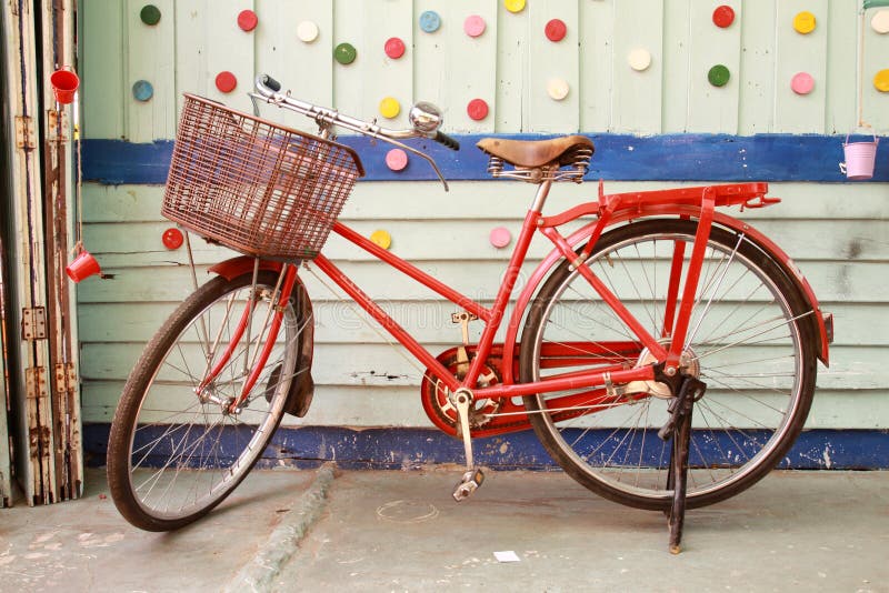 Red bicycle and colorful wood wall