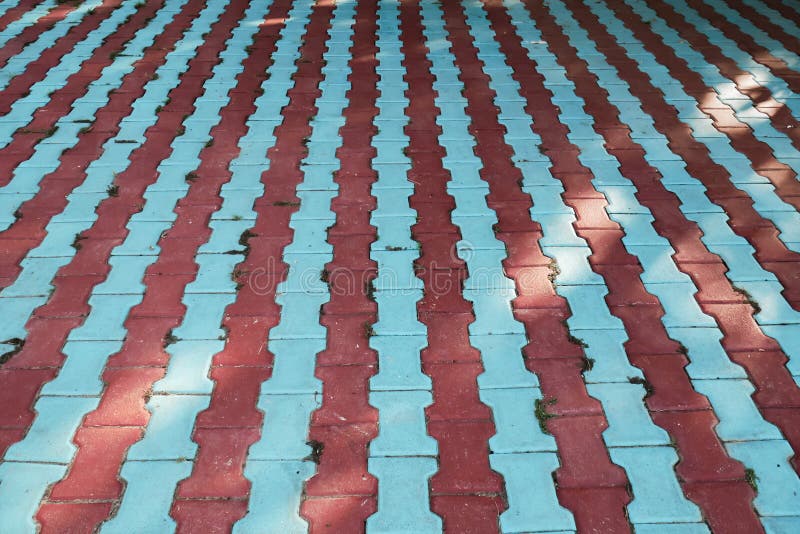 Red and blue lines made of concrete pavements, colored background with vanishing points