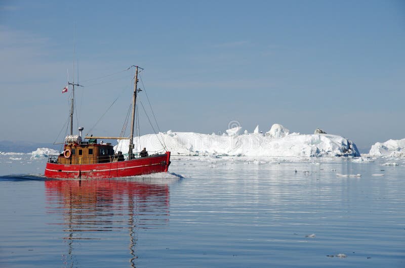 Red boat among the icebergs, Greenland