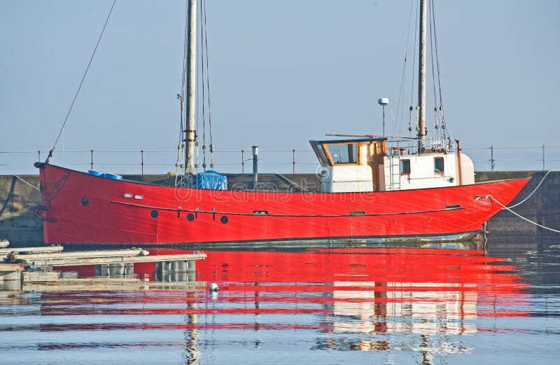 Red boat with white wheelhouse in Harbor.