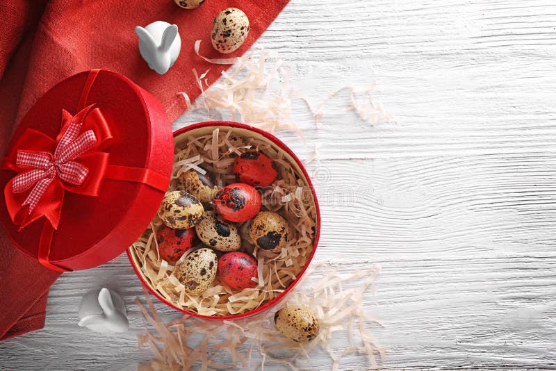 Red box with Easter eggs and rabbits stock photos Red box with Easter eggs and rabbits stock photos