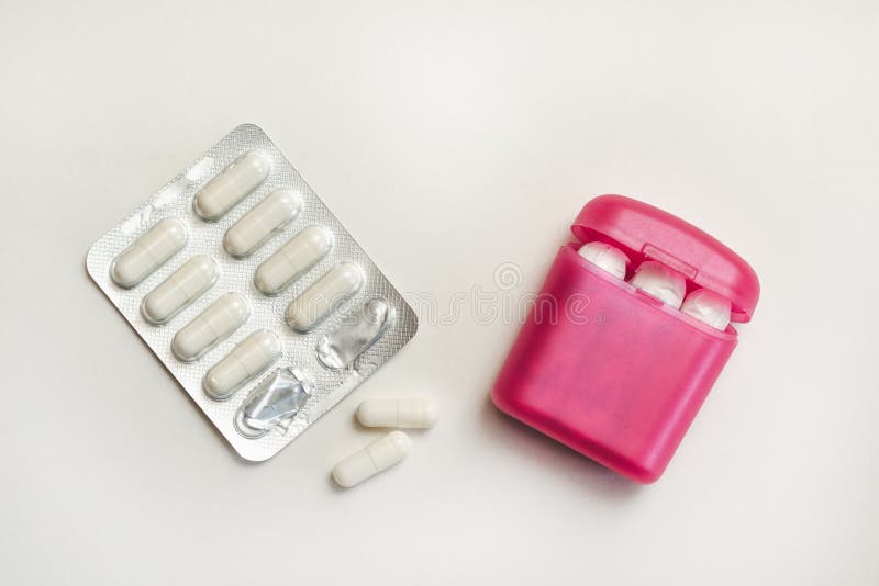 Red Box with Tampons and Blister with Pain Pills on White Surface Stock