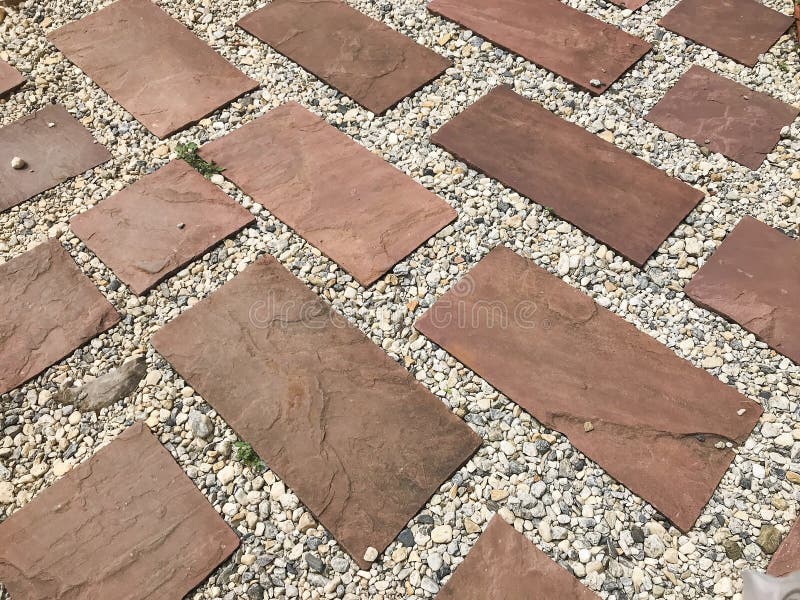 Red Brick Block Ground In Perspective Inserted With Small Stones Stock
