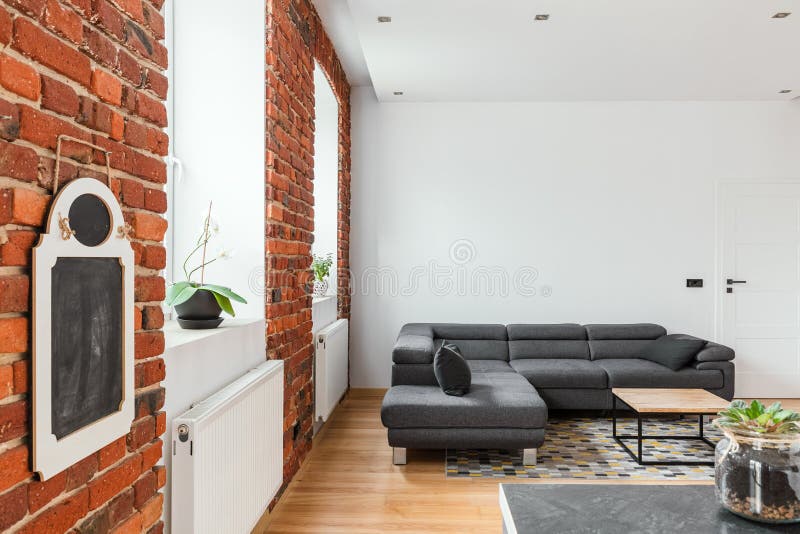 Red brick wall in contemporary apartment stock image