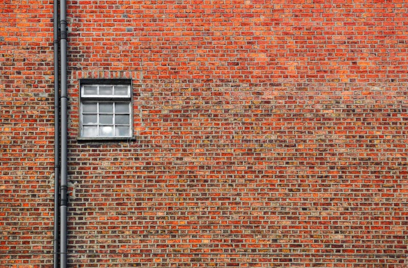 Red brick wall with small window