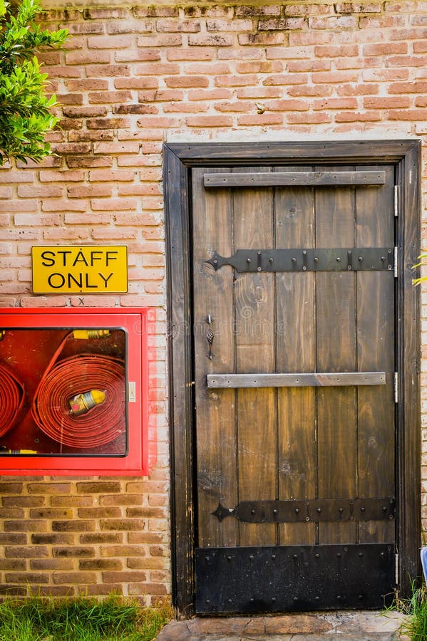 The Red brick wall and the wood closed door