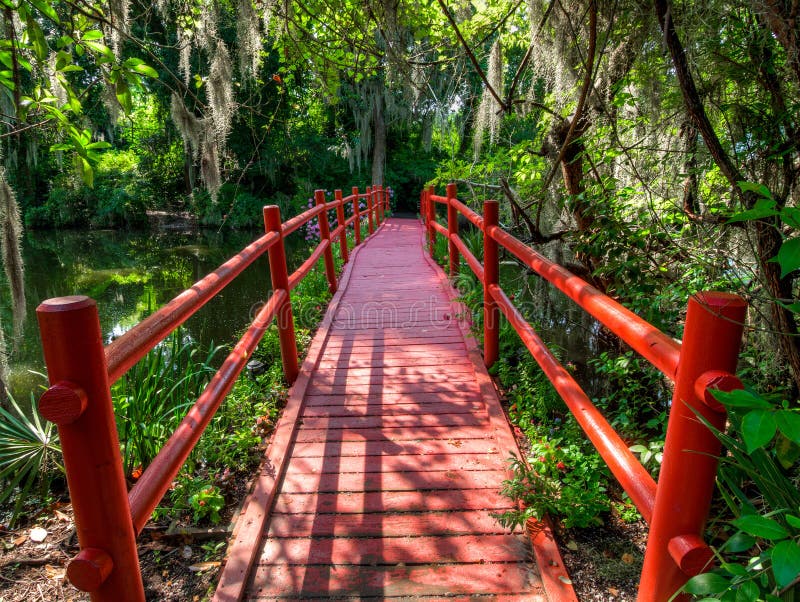 Red Bridge Over Water, with Moss Covered Trees. Charleston, SC. Stock