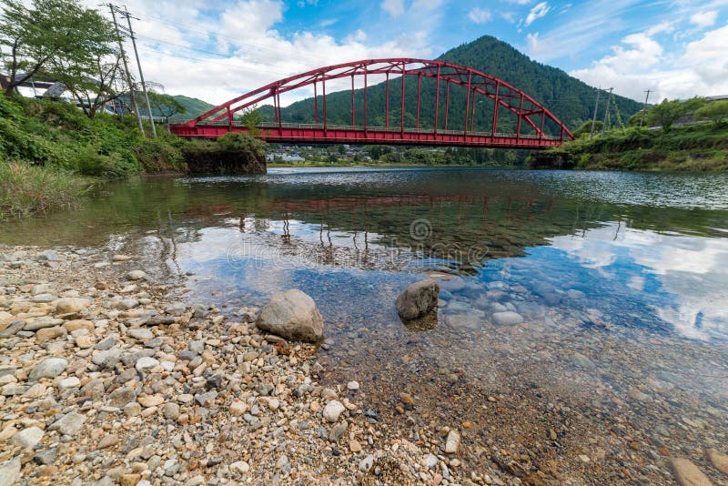 Red bridge and river in the mountain valley. Japanese countryside landscape royalty free stock photos Red bridge and river in the mountain valley. Japanese countryside landscape royalty free stock photos