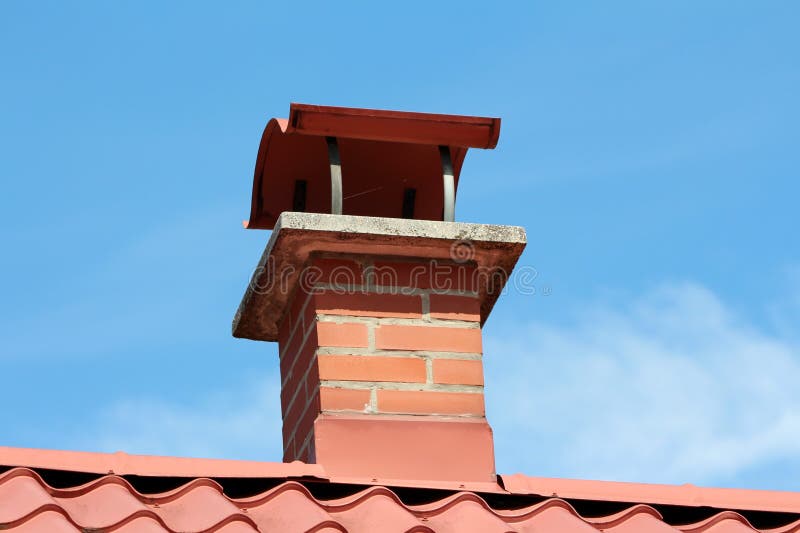 Red building bricks chimney with wavy cover mounted on top of new suburban family house roof tiles stock images Red building bricks chimney with wavy cover mounted on top of new suburban family house roof tiles stock images