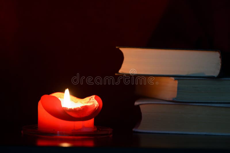 Red Burning Candle and Old Books in the Dark Stock Photo Image of