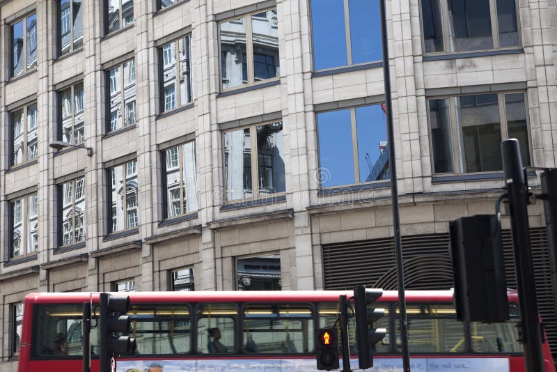 Red bus and windows from offices in UK