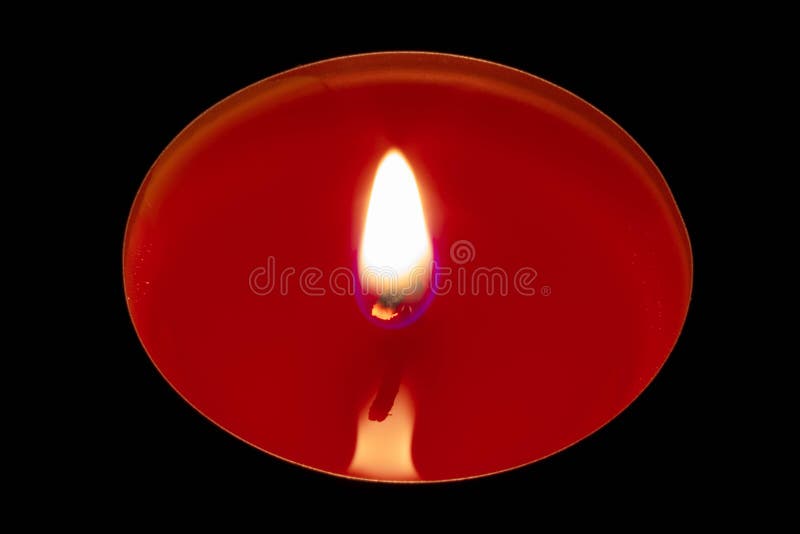 A red candle on a black background stock photos A red candle on a black background stock photos