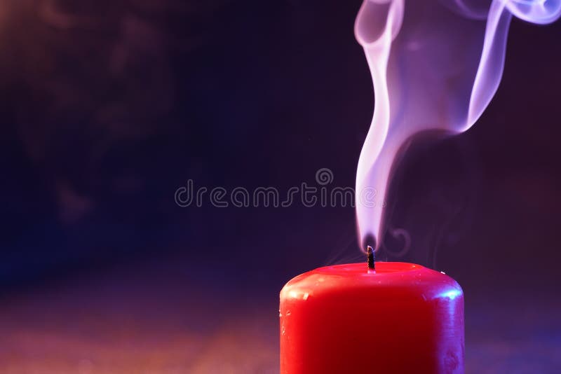 Red Candle with Smoke and Flame Photographed in the Studio with Color