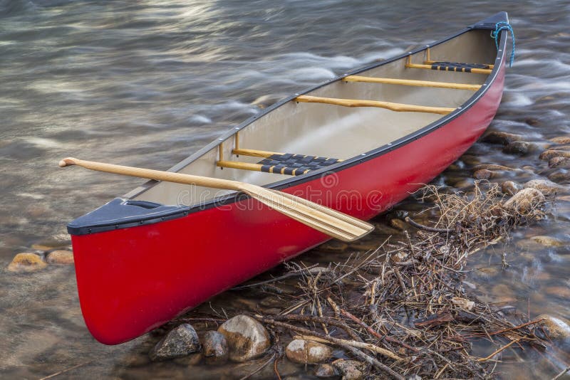 Red canoe with a paddle stock photo. Image of recreation 