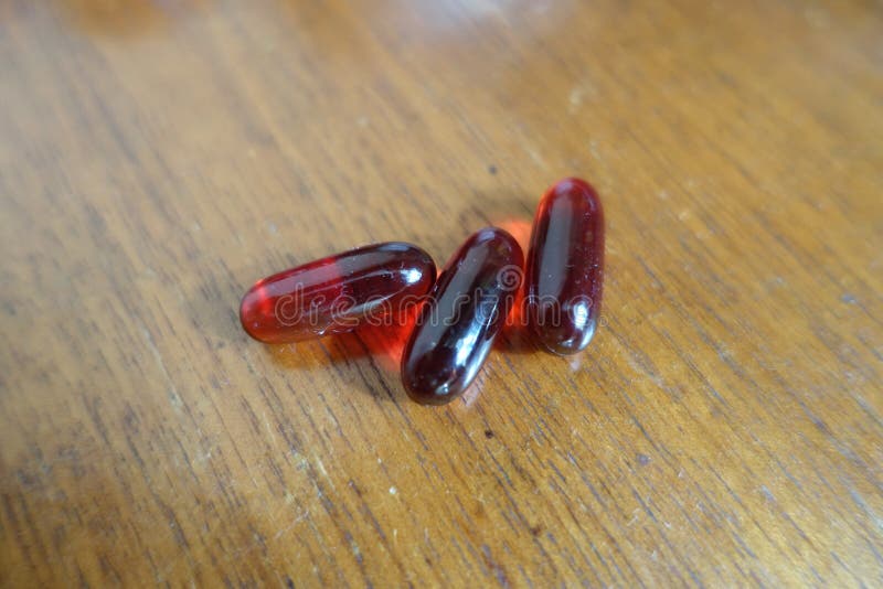 Red Capsules of Krill Oil on Wood 3 Items Stock Image Image of macro