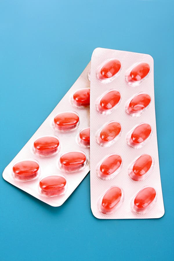 Red capsules of vitamins stock image. Image of dose, pharmaceutical