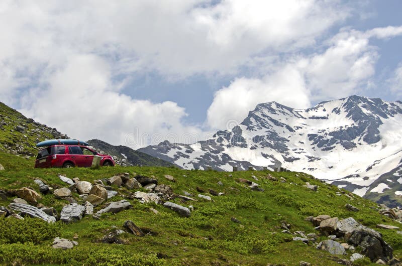 Red car climb the road in alps