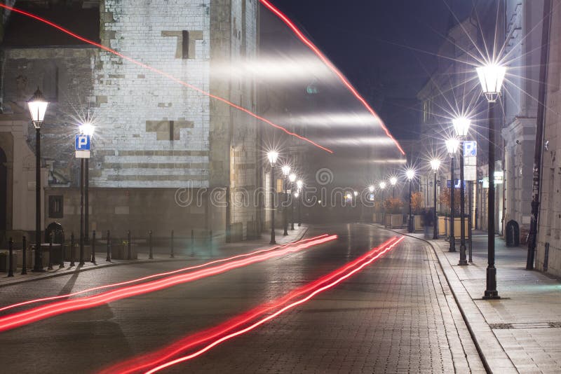 Red cars trails on the night street in Krakow stock photography Red cars trails on the night street in Krakow stock photography