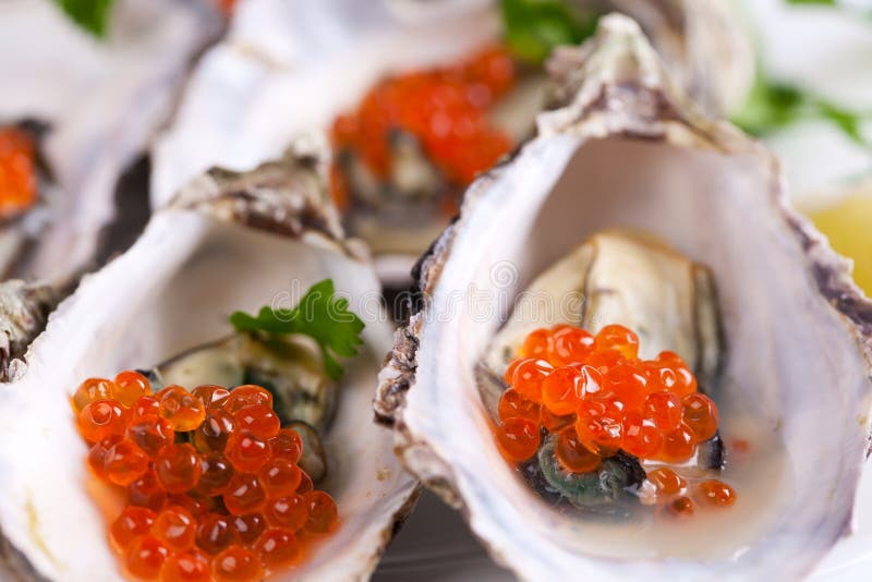 Details of red caviar in oyster shells.