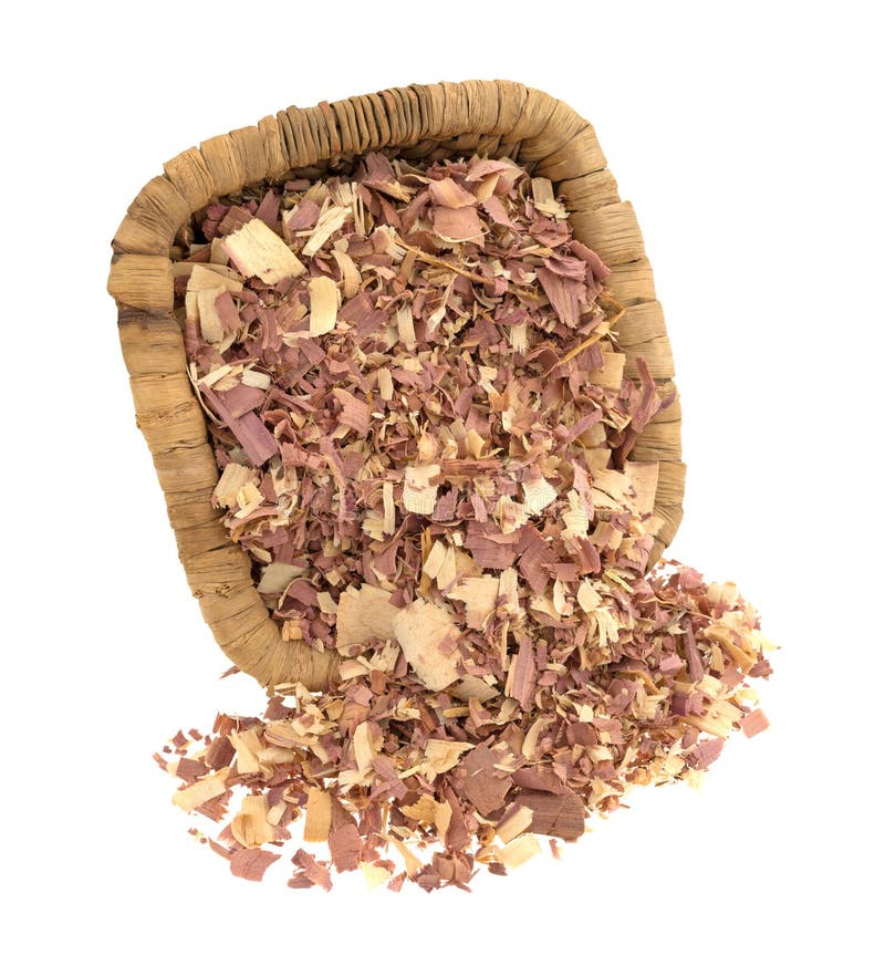 Red cedar shavings used for pet bedding spilling from an old wicker basket isolated on a white background. Red cedar shavings used for pet bedding spilling from an old wicker basket isolated on a white background.