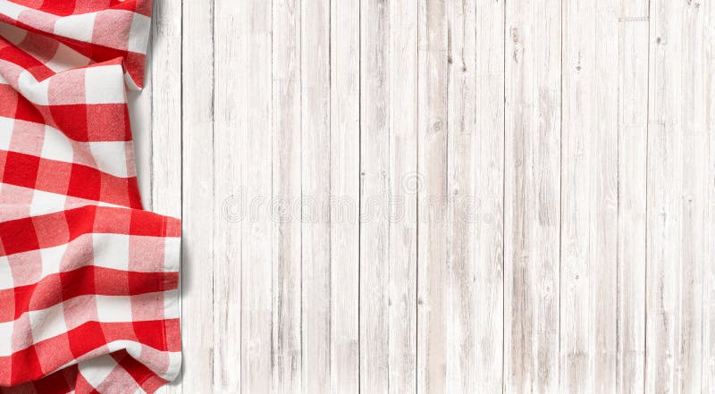 Red checkered picnic tablecloth on subtle wood table royalty free stock photos