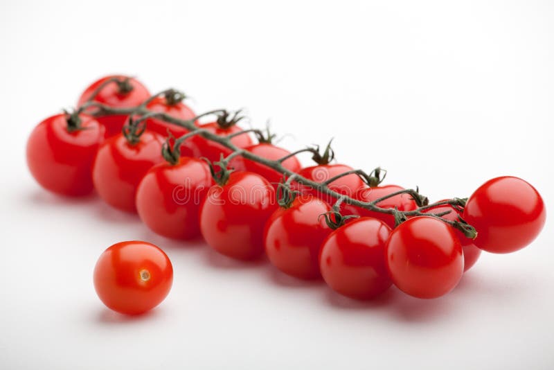 Red cherry tomatoes close-up white background