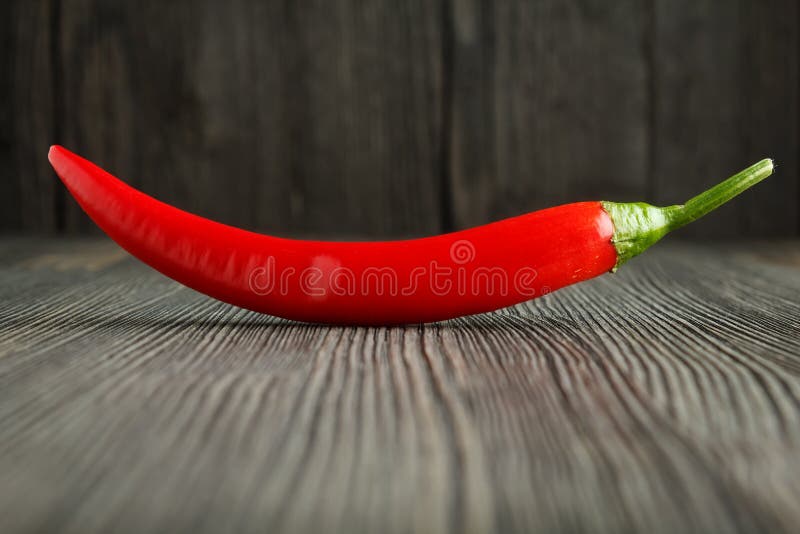 Red chili pepper on wood