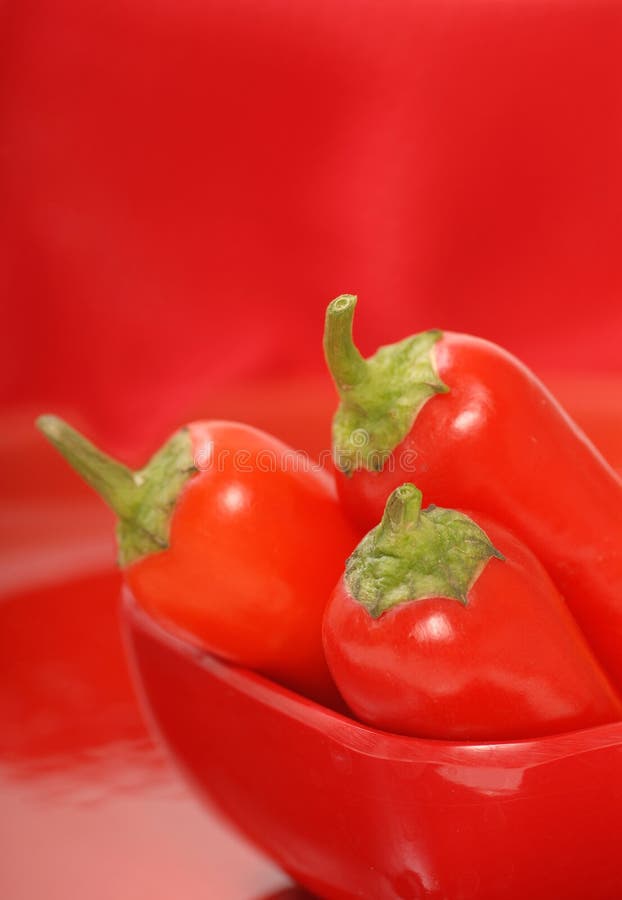 Red chili peppers in a red bowl