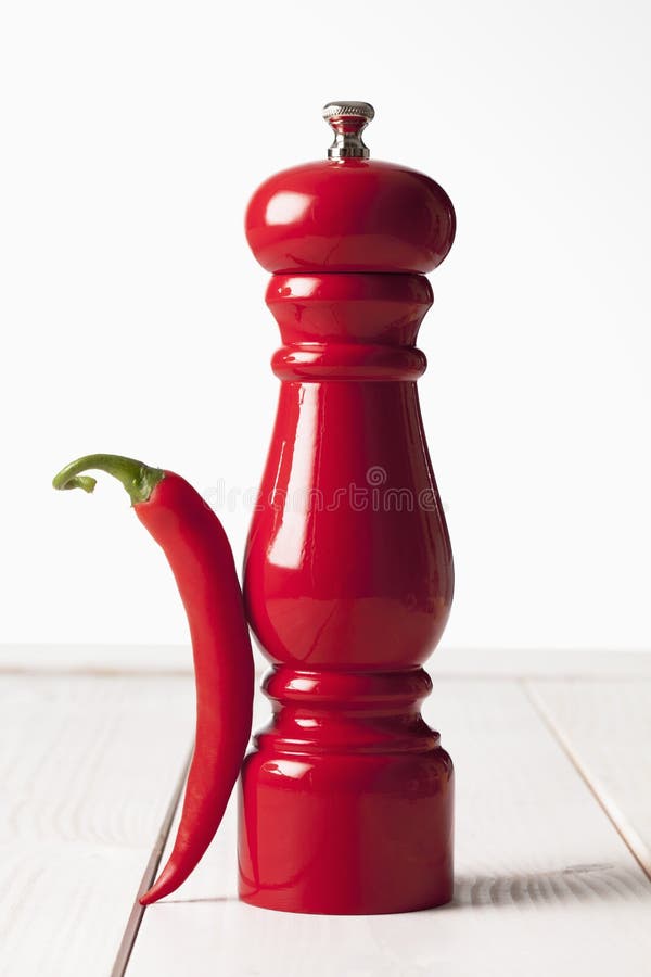 Red Chili and Red Pepper Grinder on White Wooden Table Stock Photo
