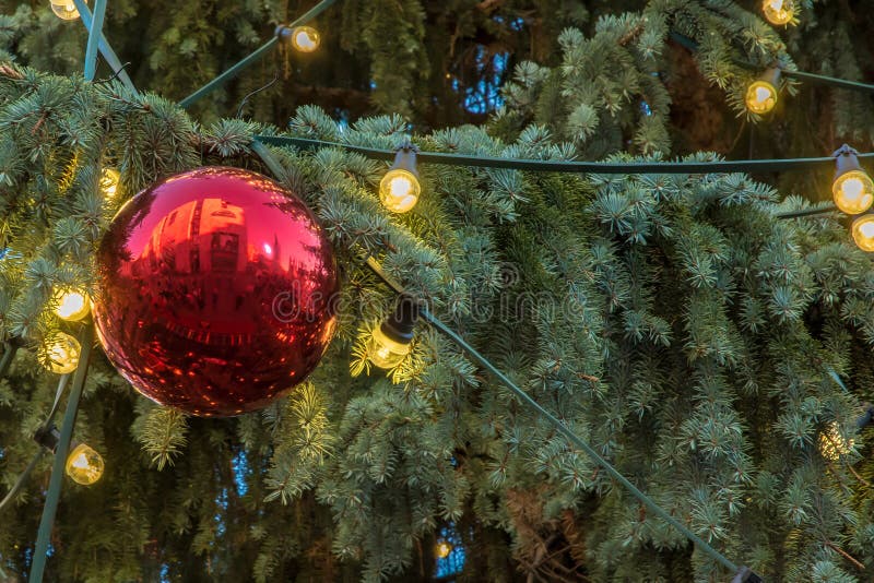 Red Christmas Tree Ball and Fairy Lights on a Christmas Tree Stock