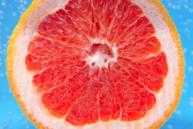 Red citrus- fruit slices of grapefruit. To close. ripe juicy fruit in water, under water, for juice stock images