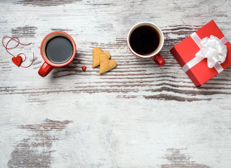 Red coffee cup, hearts cokies and gift box.